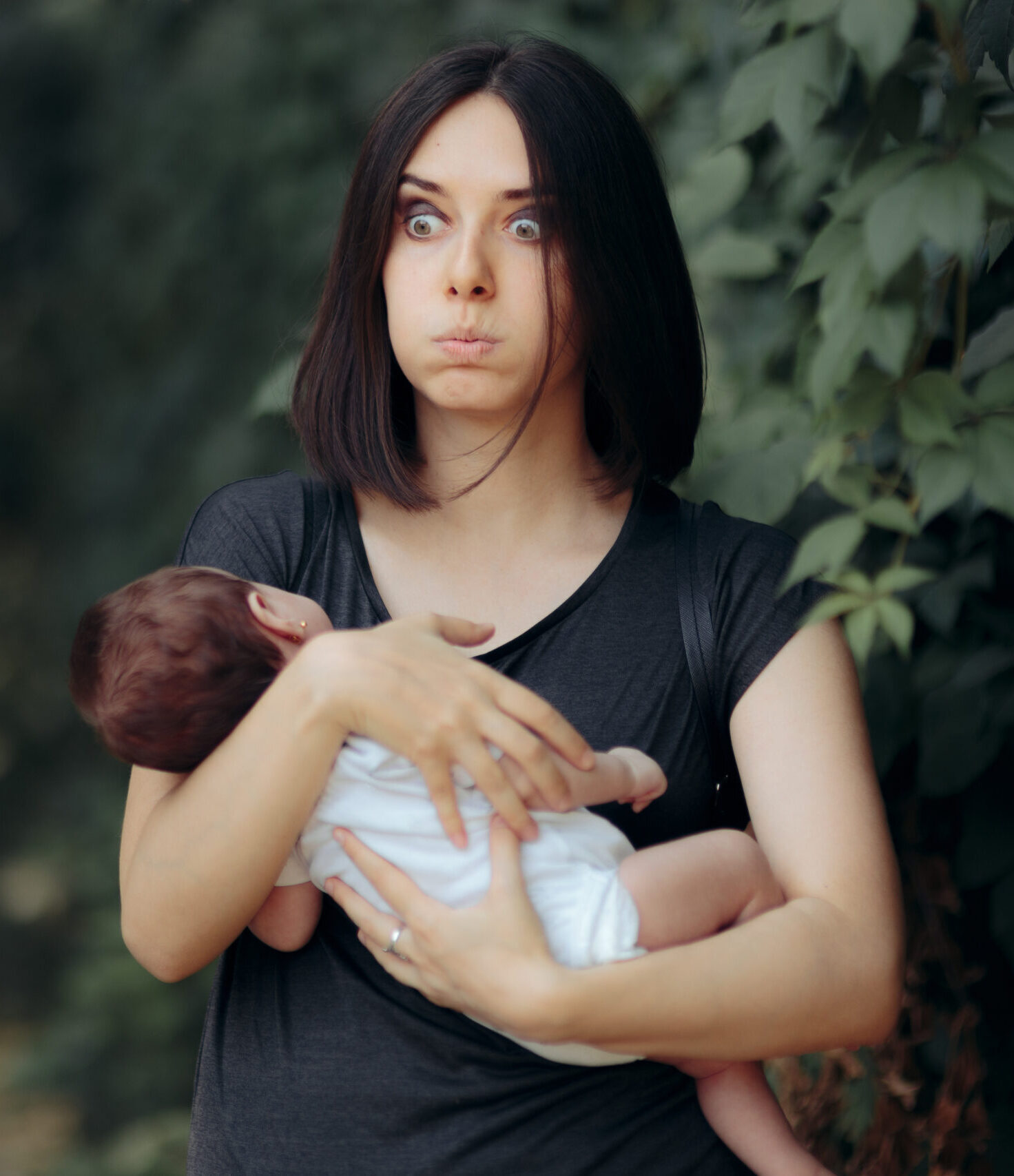 Stressed Out Mother Holding Baby Outside