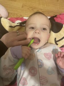 Jozie, 22 months, saying "ahhh" while practicing tooth brushing