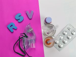 Image of the letters RSV surrounded by oxygen mask, and medications