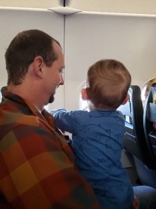 Carson and his dad on a plane looking out the window