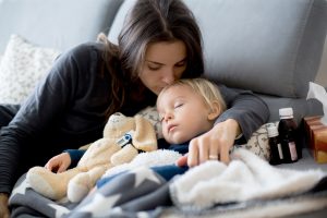 Blond toddler boy, sleeping on the couch in living room, lying d