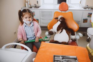 Little girl pretending to be dentist