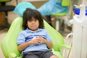 Asian child having dentist dental appointment.School kid getting teeth fixed in dental clinic.