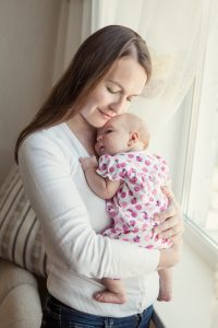 Happy mother hugging her little daughter, baby, newborn, tenderness and love, indoor