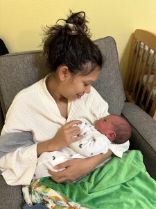 Natalia looking down at newborn Isaiah