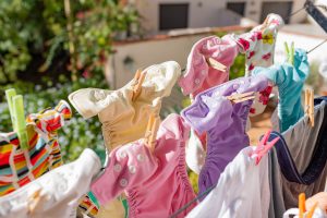 Cloth diapers hanging while drying under the sun on clothesline. 