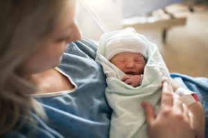 A Mother with her newborn baby at the hospital a day after a natural birth labor