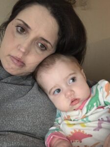Whitney and her daughter with their heads together looking sad