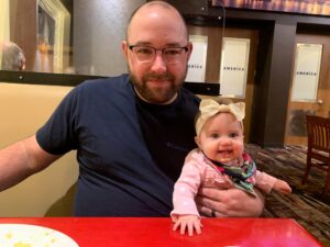 Tony and daughter looking at the camera.