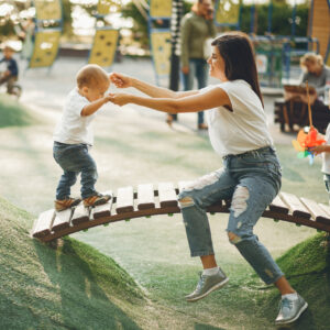 Mother with toddler son at the playground.